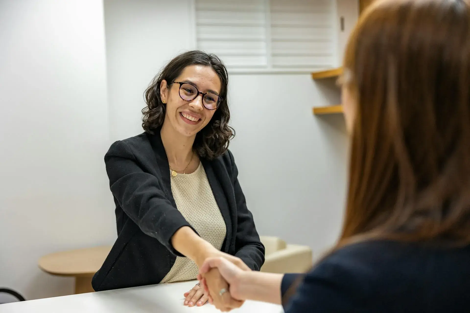 A woman shaking another woman's hand
