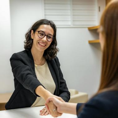 A woman shaking another woman's hand